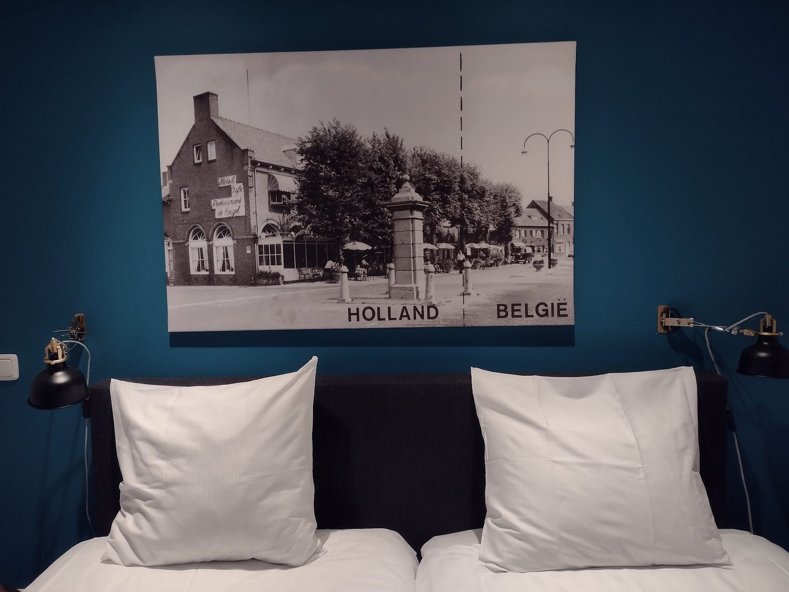 An ordinary hotel bedroom with a photo showing the historical border crossing
