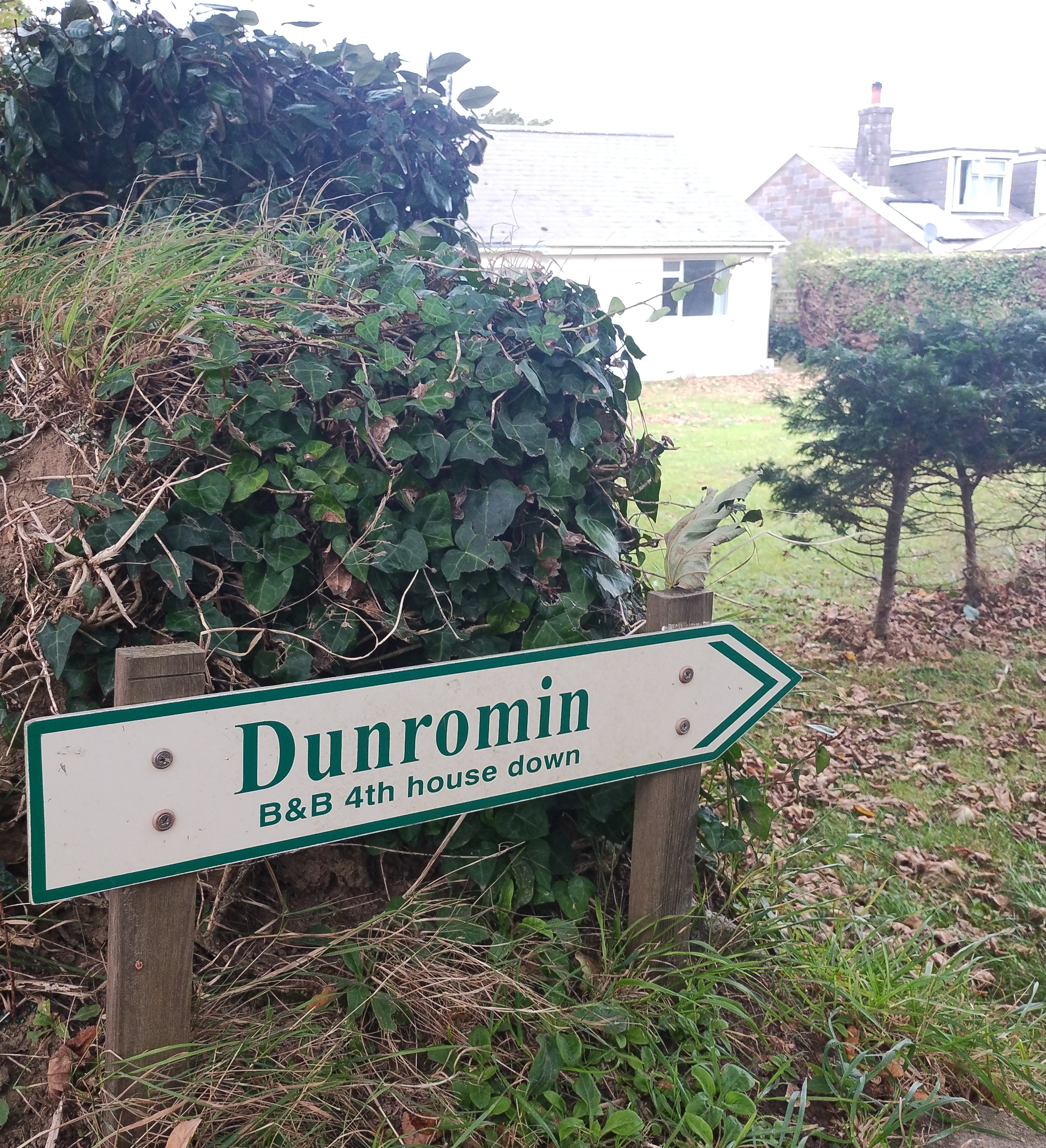 A B&B sign has an arrow and text saying 4th House Down